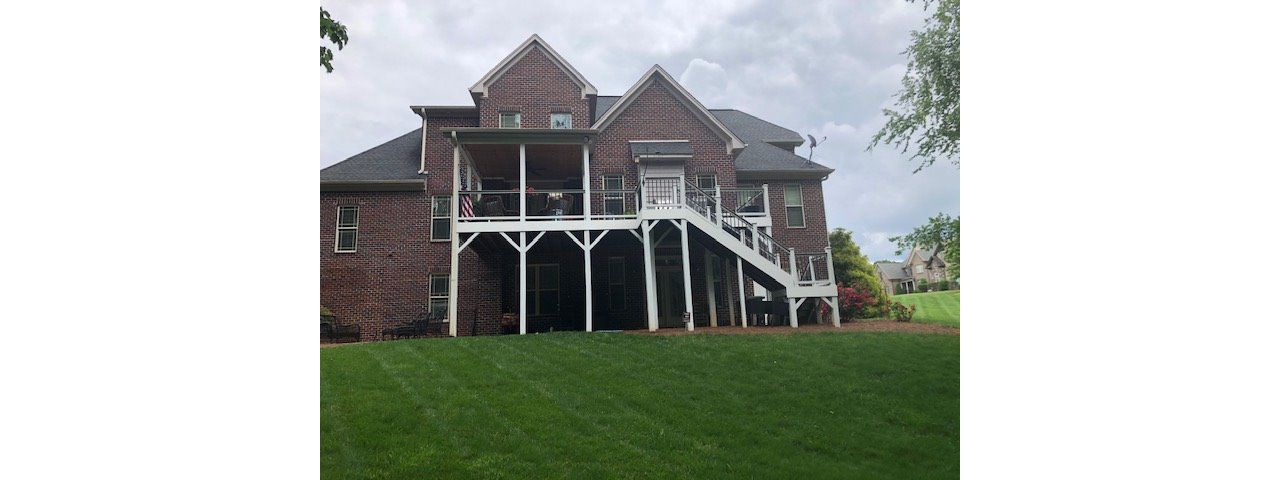 Incredible new Trex Select Pebble Grey decking & Select Classic white railing on deck & covered porch in Pfaftown, NC