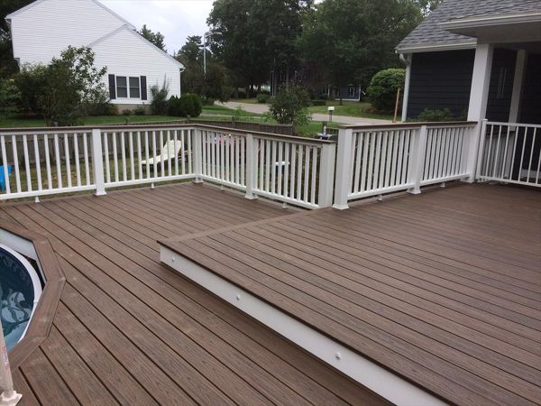 Trex Spiced Rum decking and cocktail railings built around new above ground pool.  Also some riser lights to highlight the step down