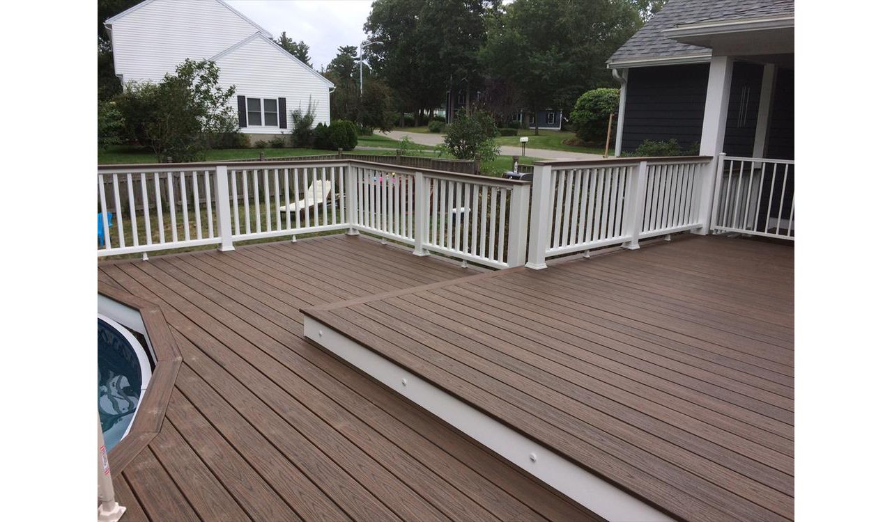 Trex Spiced Rum decking and cocktail railings built around new above ground pool.  Also some riser lights to highlight the step down