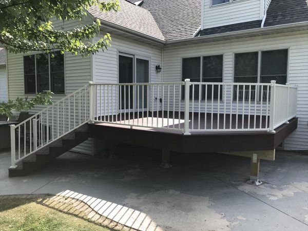 Trex Select Madeira decking with Trex Signature aluminum white railings and post cap lighting by GE Contracting LLC in Appleton, WI