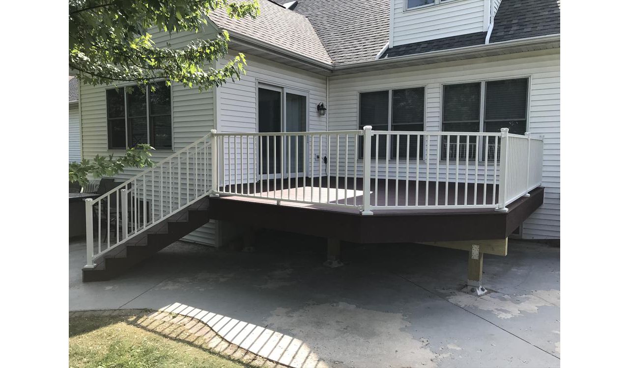 Trex Select Madeira decking with Trex Signature aluminum white railings and post cap lighting by GE Contracting LLC in Appleton, WI