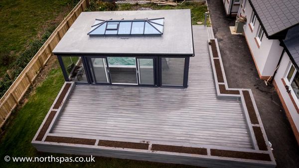 A sea of Grey Island Mist surrounding a swim spa with decorative planters