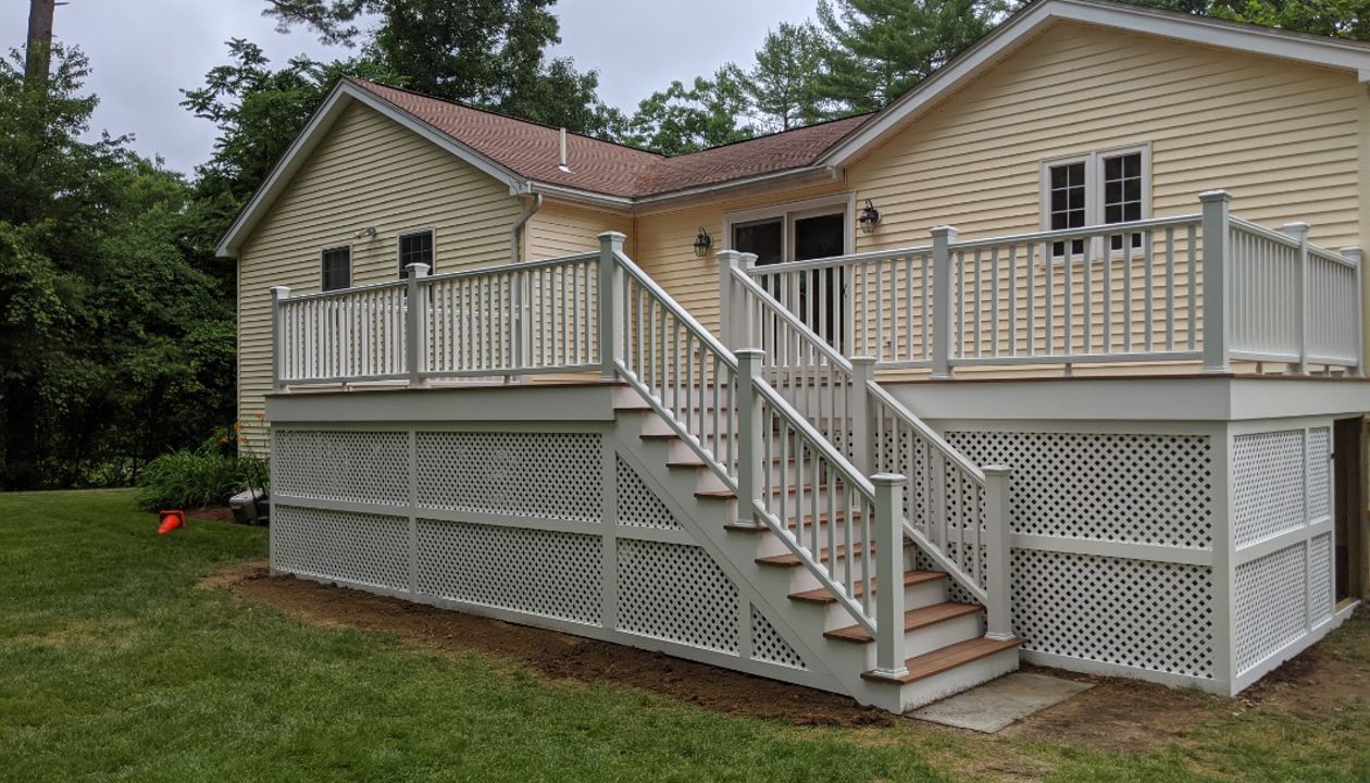 Trex Transcend "Tiki Torch" decking with white Transcend railings.