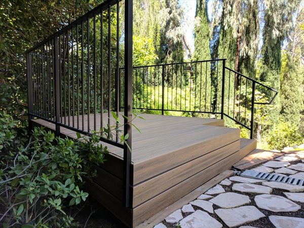 Custom Trex Havana Gold Deck in Redding, with hidden fasteners and custom railing in a backyard.  Majestic Builders is proud to provide top quality composite decks that will last a lifetime.