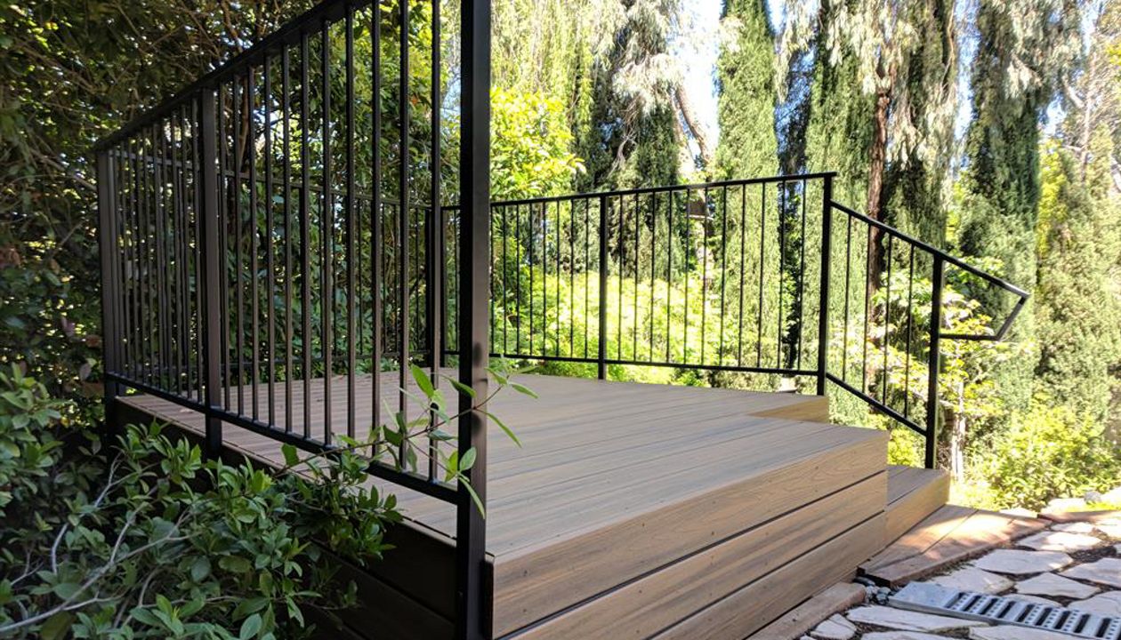 Custom Trex Havana Gold Deck in Redding, with hidden fasteners and custom railing in a backyard.  Majestic Builders is proud to provide top quality composite decks that will last a lifetime.