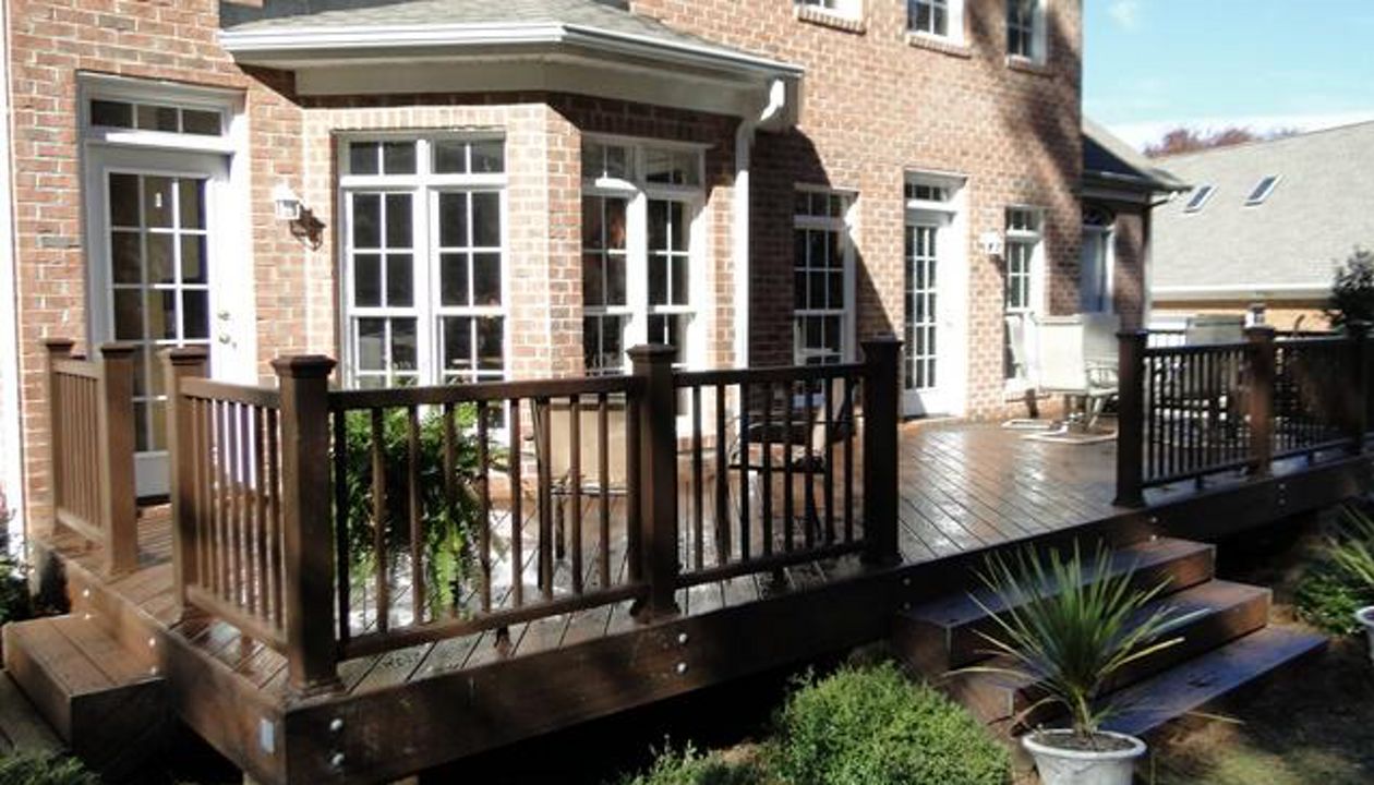 Trex Transcend Lava Rock compliments this brick home