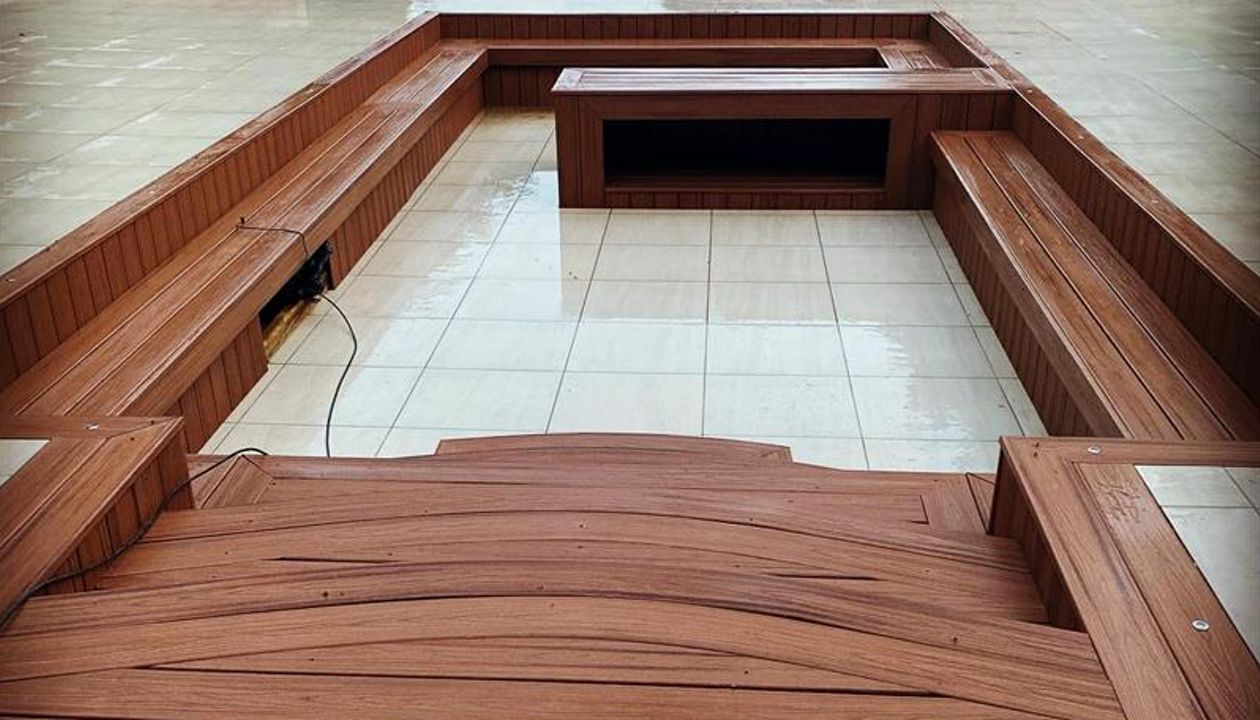 Trex Transcend Tiki Torch sunken entertaining area with Custom Curve Steps fitted at Swansea Wales UK.