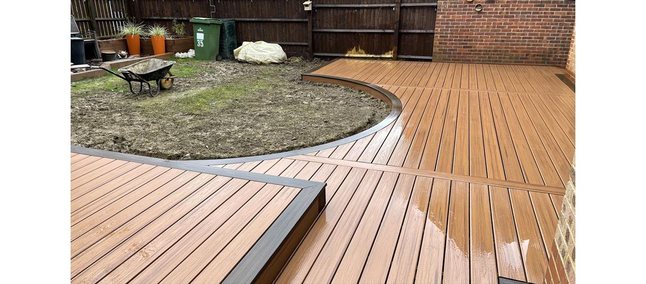 A stunning custom curved deck using trex tiki touch and spiced rum for a boarder both from the transcend range