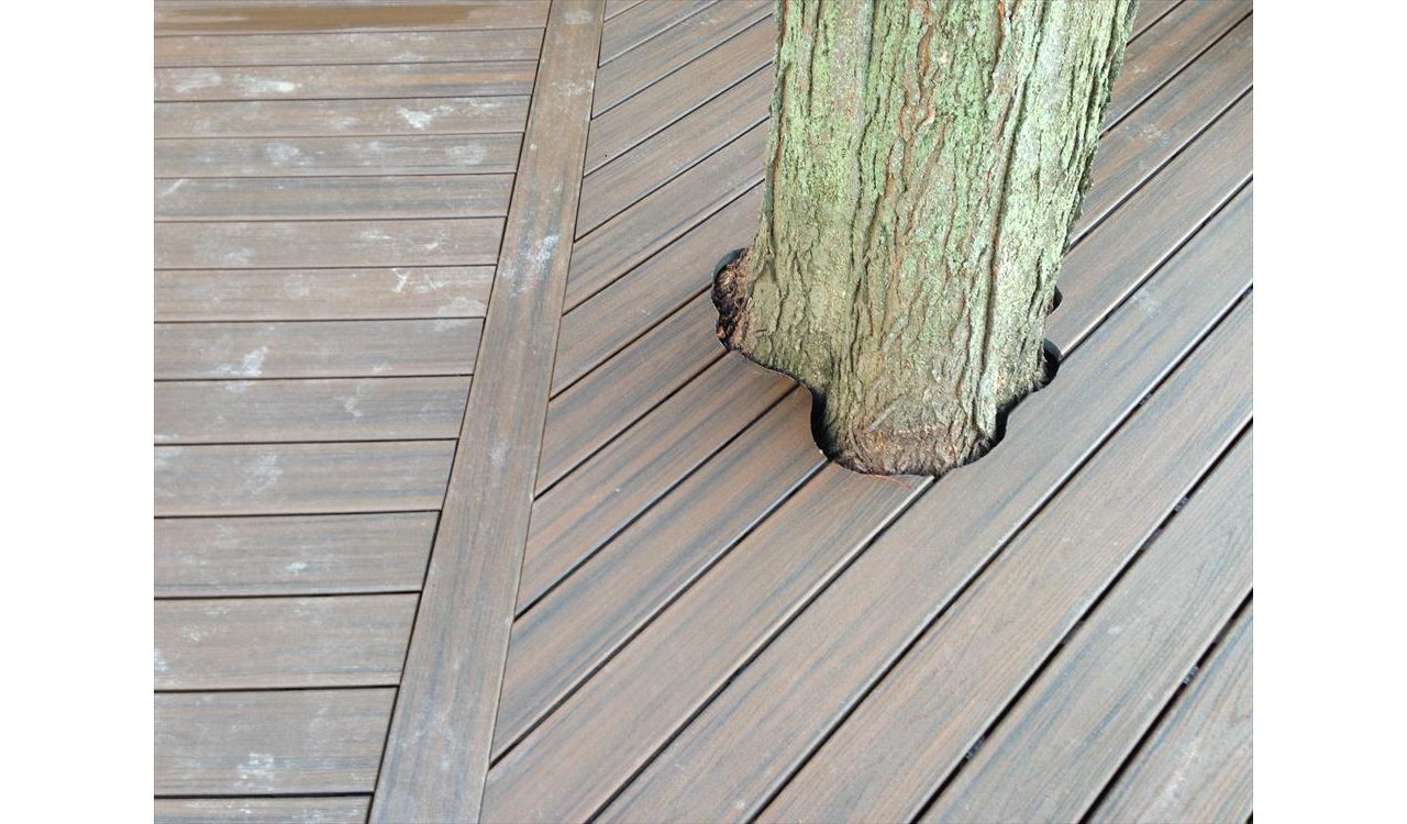 Check out this Trex deck Images Landscaping Image and Construction built in Northville, MI out of Trex Transcend Spiced Rum decking, with special cuts made as to keep the beautiful old tree as part of the outdoor living space.
