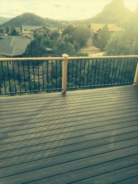 Prescott AZ.  Lava Rock with groove, hidden clips. Trex joist tape.  Metal railing and redwood top cap.