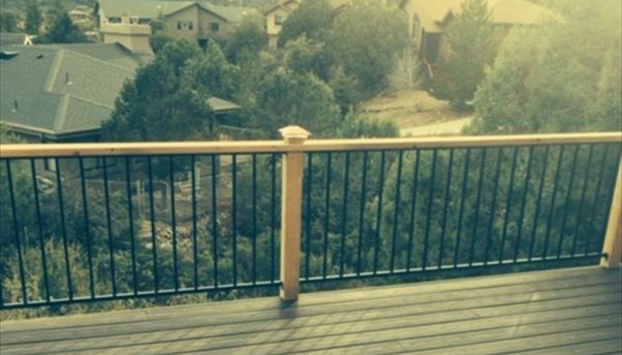 Prescott AZ.  Lava Rock with groove, hidden clips. Trex joist tape.  Metal railing and redwood top cap.