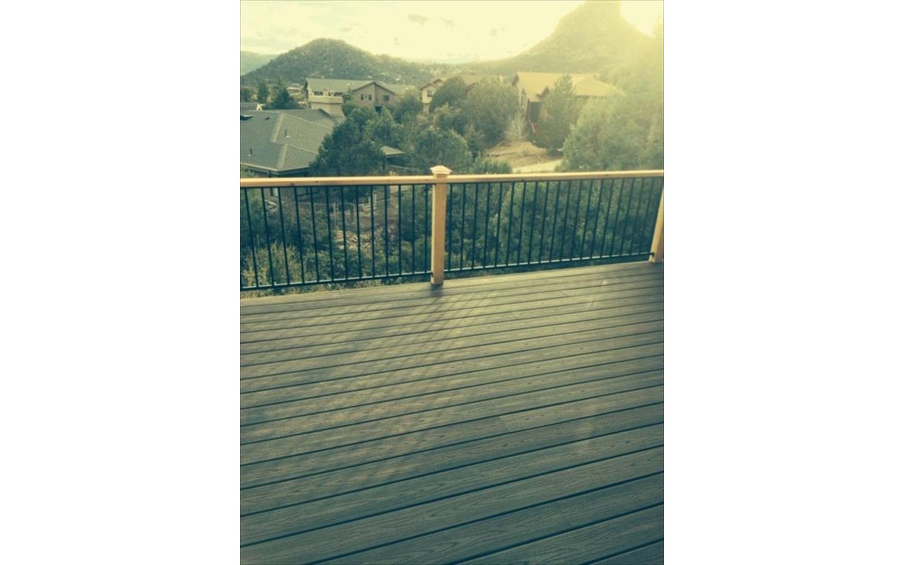 Prescott AZ.  Lava Rock with groove, hidden clips. Trex joist tape.  Metal railing and redwood top cap.