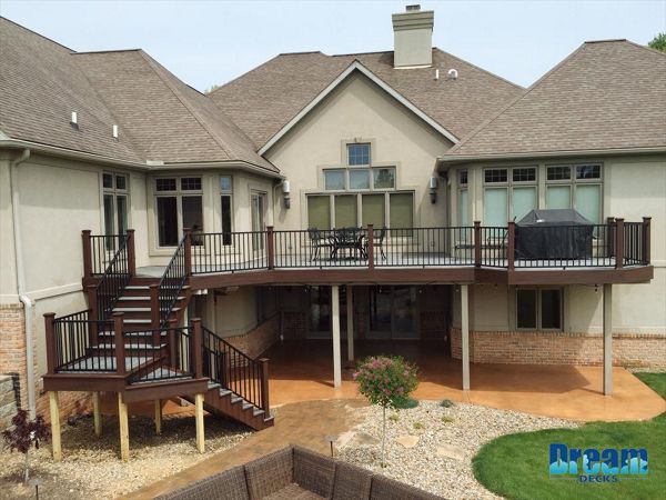 Spacious Trex deck with elevated seating areas for family relaxation.