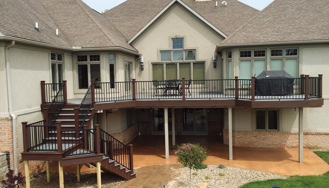 Spacious Trex deck with elevated seating areas for family relaxation.