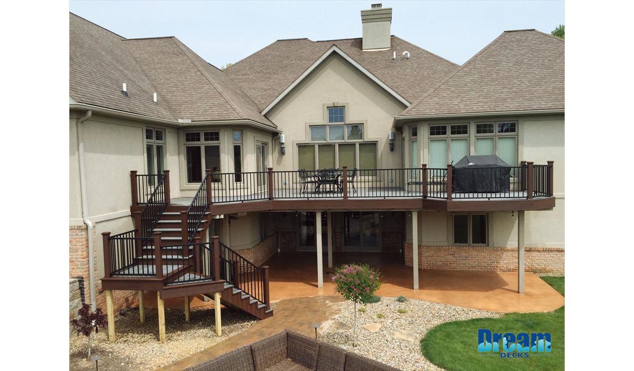 Spacious Trex deck with elevated seating areas for family relaxation.