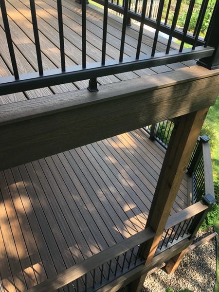 Trex/Transcend/Spiced Rum Composite Decking with Trex/Transcend Universal Composite Railing (black with round aluminum balusters) and Trex/Transcend Spiced Rum Composite Decking with Trex/Post Cap Accent Lighting