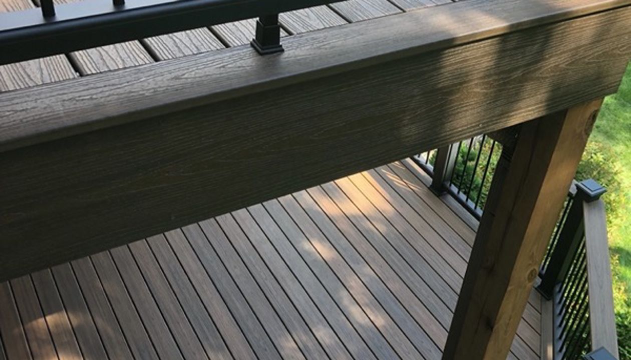Trex/Transcend/Spiced Rum Composite Decking with Trex/Transcend Universal Composite Railing (black with round aluminum balusters) and Trex/Transcend Spiced Rum Composite Decking with Trex/Post Cap Accent Lighting