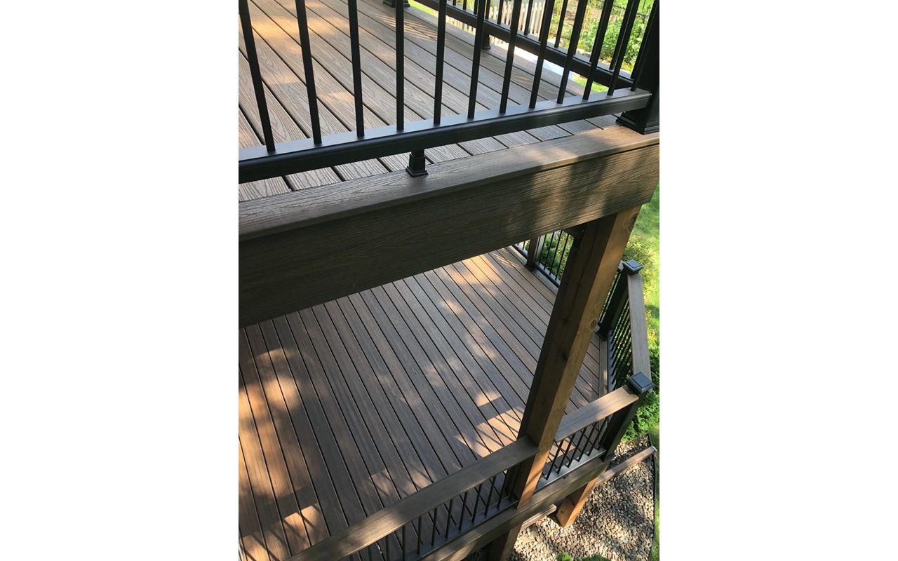 Trex/Transcend/Spiced Rum Composite Decking with Trex/Transcend Universal Composite Railing (black with round aluminum balusters) and Trex/Transcend Spiced Rum Composite Decking with Trex/Post Cap Accent Lighting