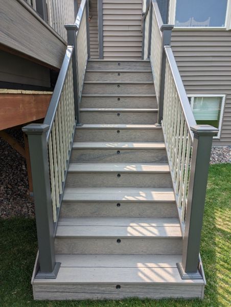 Trex composite lineage decking, Biscayne in color, Trex riser lights with lighted post tops.