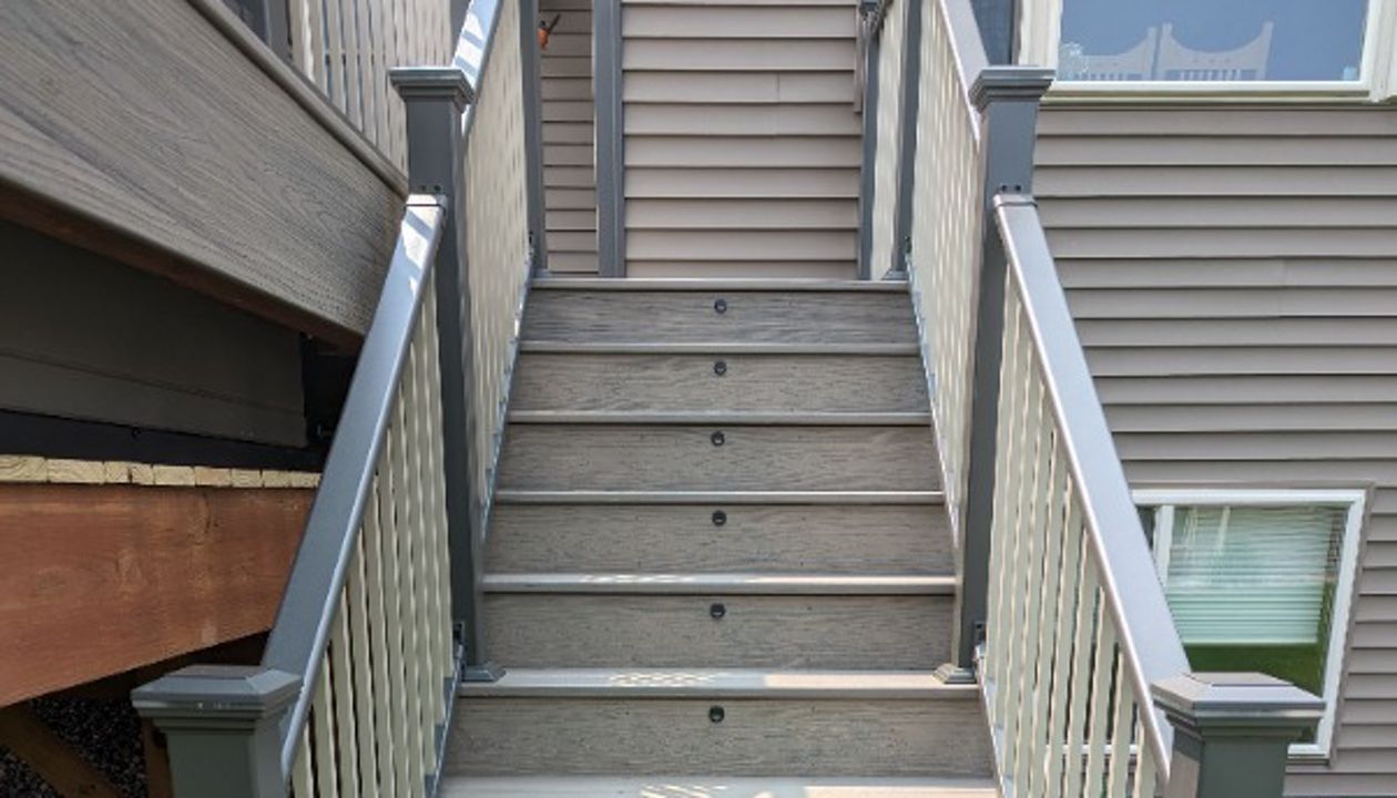 Trex composite lineage decking, Biscayne in color, Trex riser lights with lighted post tops.