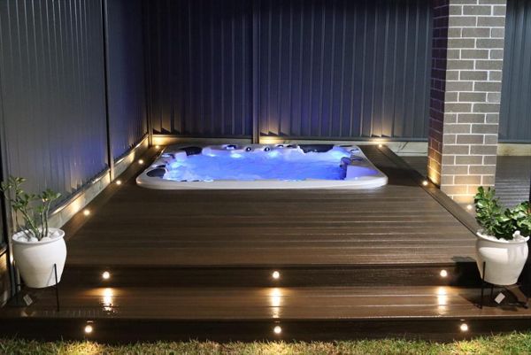 Trex spiced rum spa deck with trex riser and decking lights.