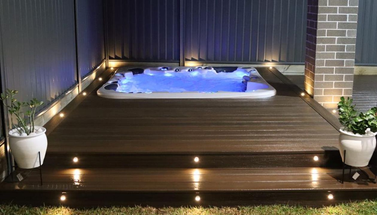 Trex spiced rum spa deck with trex riser and decking lights.