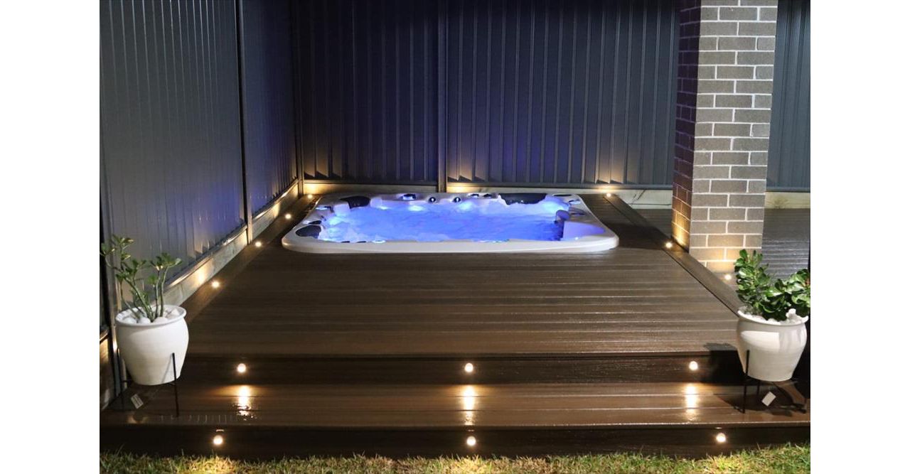 Trex spiced rum spa deck with trex riser and decking lights.