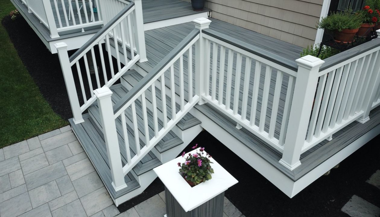 Amazing 2-Tier 500 Square Foot Outdoor Living Deck Space, Trex Transcend Island Mist Decking with Trex Transcend White Composite Railings and Island Mist Cocktail Rails, in Peabody, MA