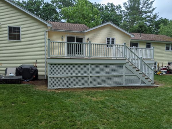 Trex Transcend "Tiki Torch" decking with white Transcend railings.