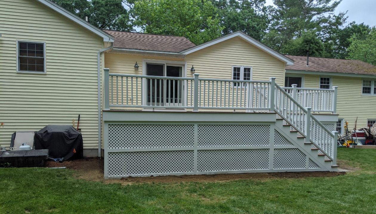 Trex Transcend "Tiki Torch" decking with white Transcend railings.