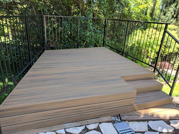 Custom Trex Havana Gold Deck in Redding, with hidden fasteners and custom railing in a backyard.  Majestic Builders is proud to provide top quality composite decks that will last a lifetime.