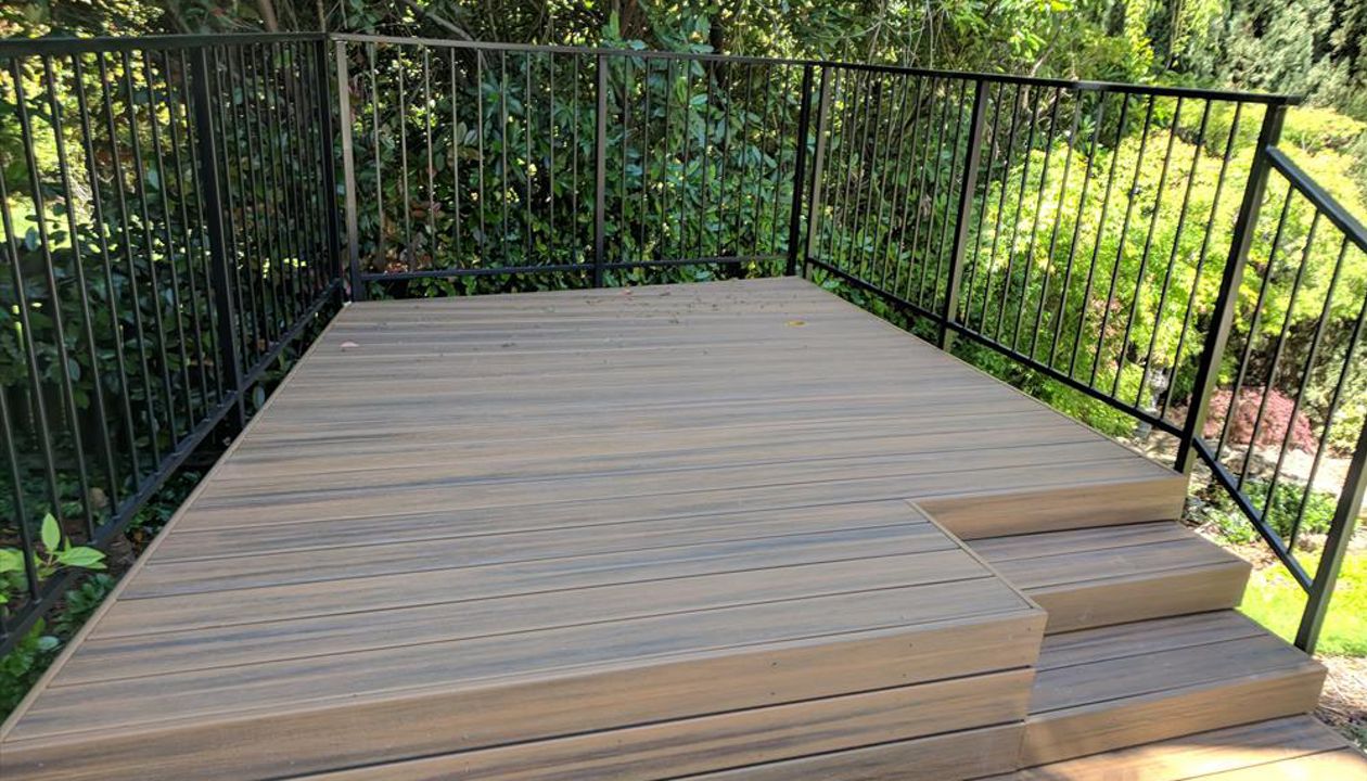 Custom Trex Havana Gold Deck in Redding, with hidden fasteners and custom railing in a backyard.  Majestic Builders is proud to provide top quality composite decks that will last a lifetime.