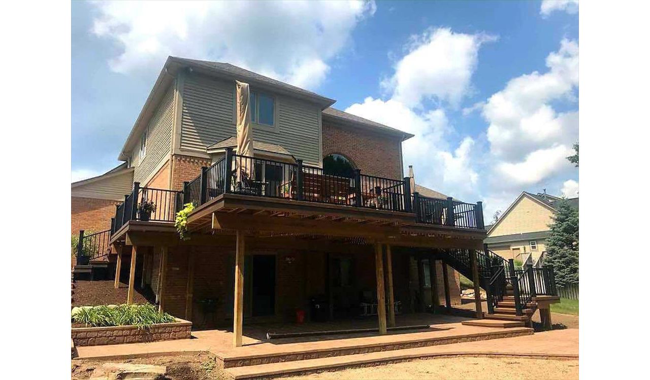 Spiced rum deck with Lava Rock border, black trex post sleeves, black signature rail, and big open spaces underneath from the GLU-Laminate Beam addition