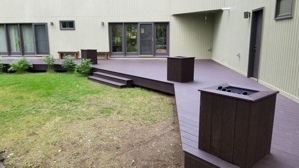 Trex select woodland brown decking and custom built flower boxes made from woodland brown fascia boards