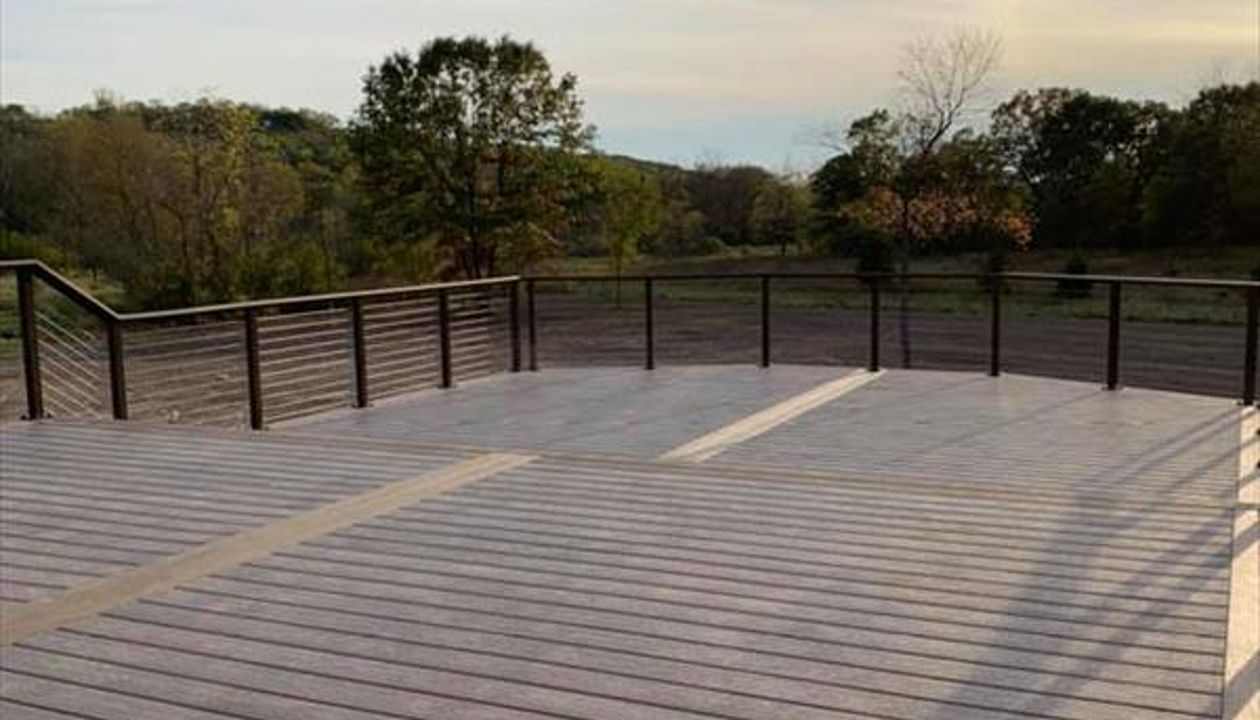 This deck features Trex enhance rocky harbor as main deck and Trex enhanced toasted sand as picture frame/middle divider.