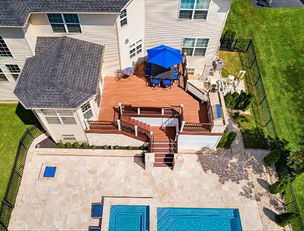 Trex Transcend Tiki Torch and Lava Rock Deck with Vintage Lantern and White rail.