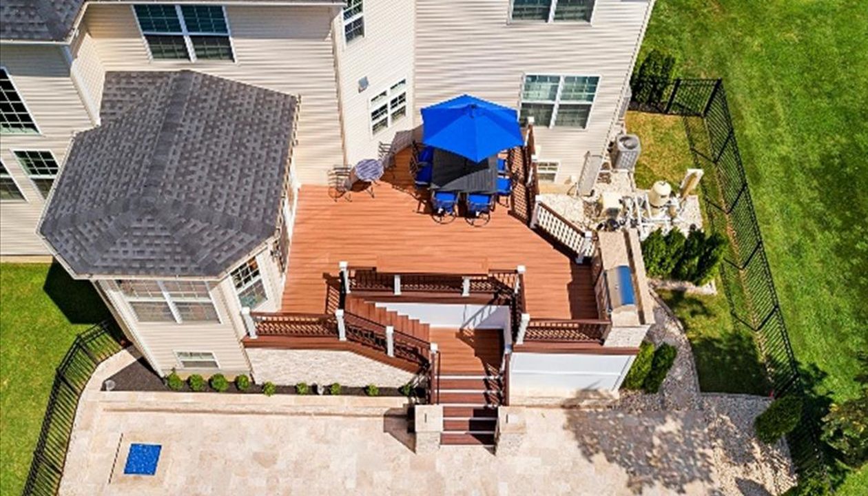 Trex Transcend Tiki Torch and Lava Rock Deck with Vintage Lantern and White rail.