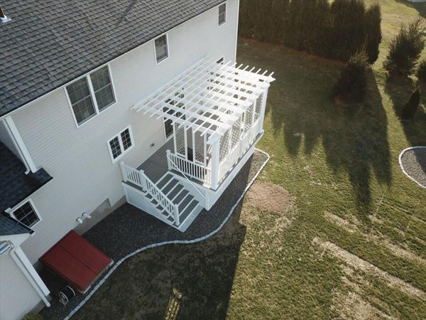 Trex Gravel Path Decking, Trex Pergola &amp; Railing system. Custom privacy lattice above the deck and custom lattice for storage area below