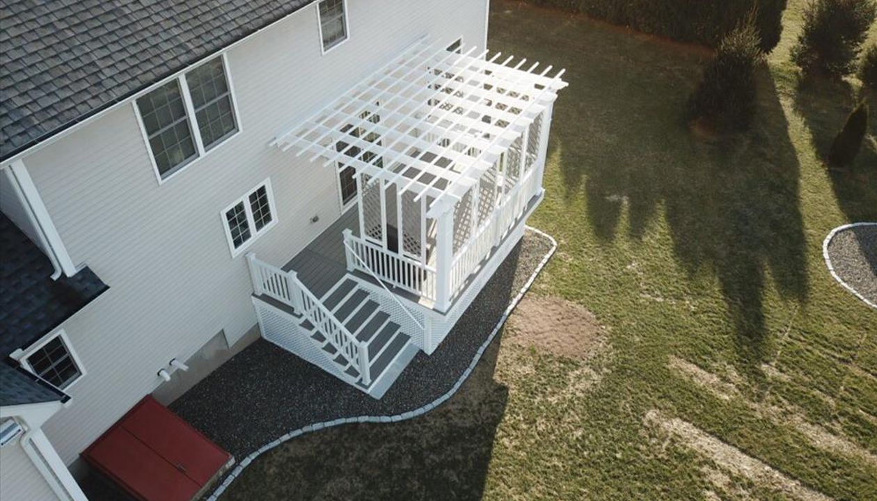 Trex Gravel Path Decking, Trex Pergola &amp; Railing system. Custom privacy lattice above the deck and custom lattice for storage area below