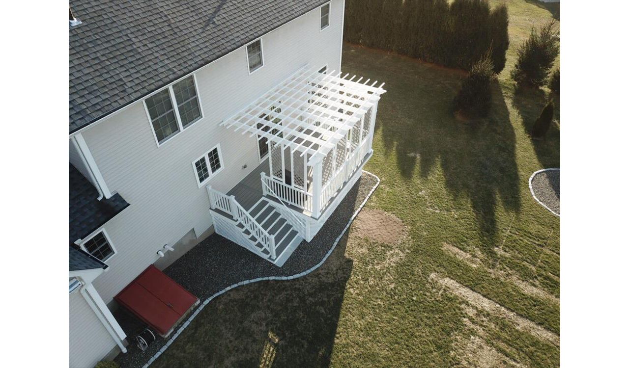 Trex Gravel Path Decking, Trex Pergola &amp; Railing system. Custom privacy lattice above the deck and custom lattice for storage area below