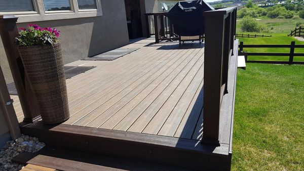 Trex Transcends Tiki Torch decking, spiced rum fascia,drink rail, & vintage lantern composite rails