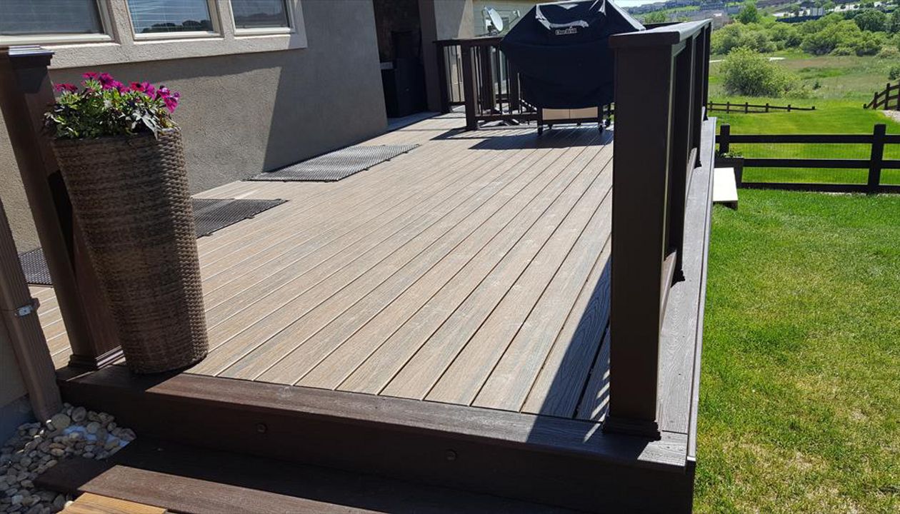 Trex Transcends Tiki Torch decking, spiced rum fascia,drink rail, & vintage lantern composite rails