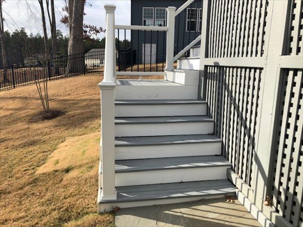 Trex Enhance Naturals Foggy Wharf deck with Transcend white handrails welcomes you to the outdoor living space