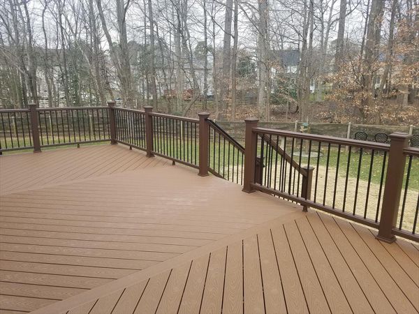 This top view highlights the triple herringbone floor with accent boards. Also, a nice look at Vintage Lantern railing with black round aluminum balusters.