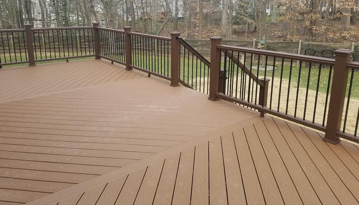This top view highlights the triple herringbone floor with accent boards. Also, a nice look at Vintage Lantern railing with black round aluminum balusters.