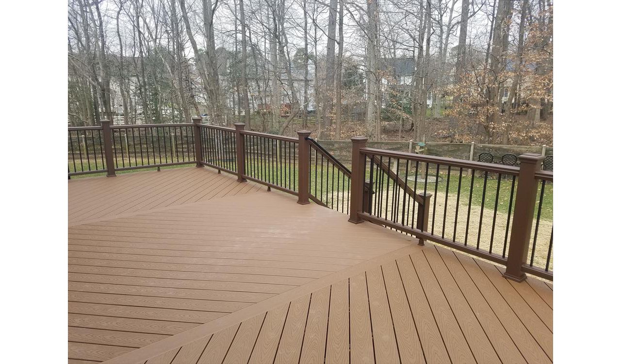 This top view highlights the triple herringbone floor with accent boards. Also, a nice look at Vintage Lantern railing with black round aluminum balusters.