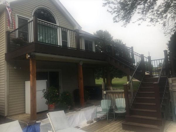 Rear deck with Trex Transcends Spiced Rum and Vintage Lantern border and fascia. Main deck also has Rain Escapes to protect the hot tub.  New steps spit to yard and pool deck