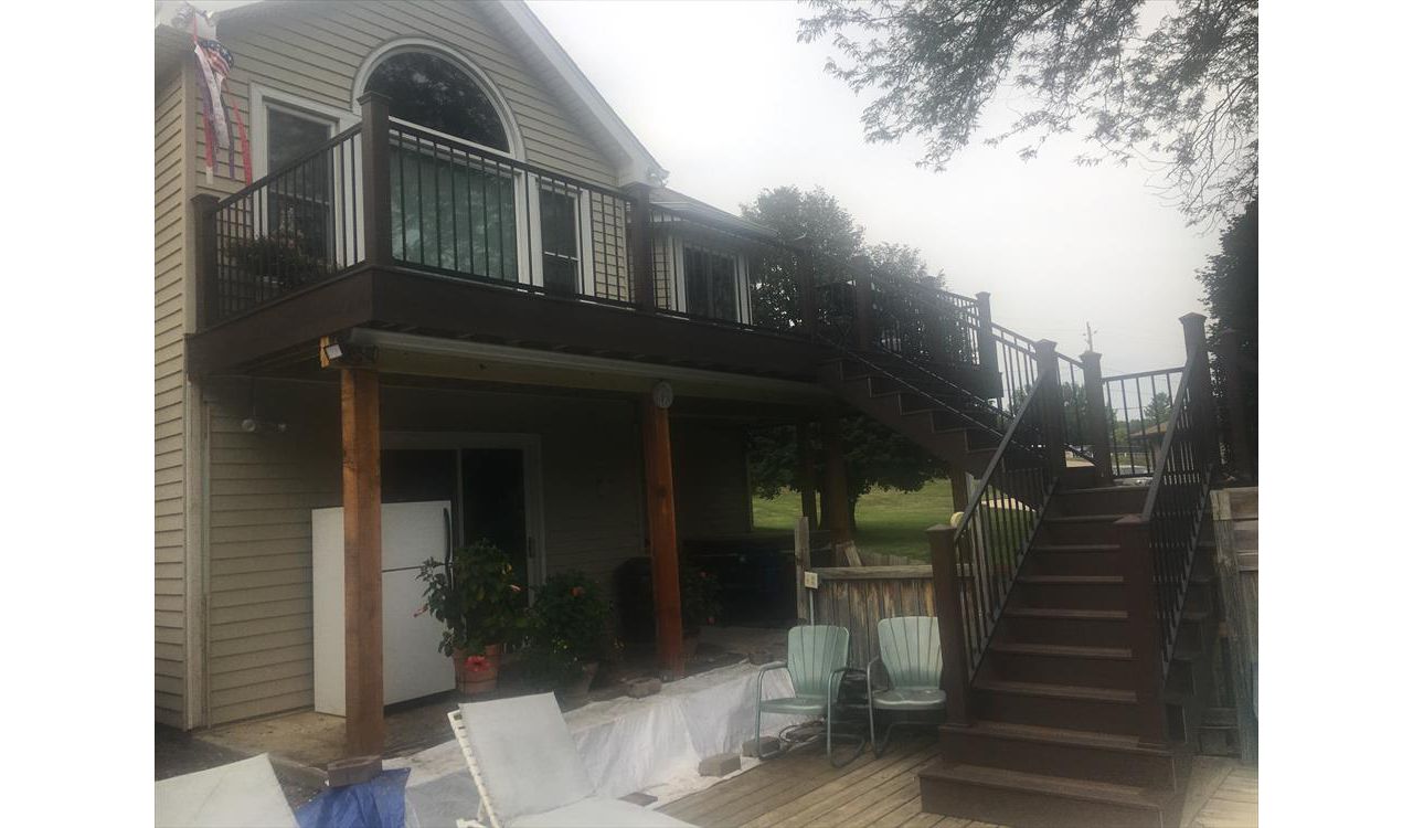 Rear deck with Trex Transcends Spiced Rum and Vintage Lantern border and fascia. Main deck also has Rain Escapes to protect the hot tub.  New steps spit to yard and pool deck