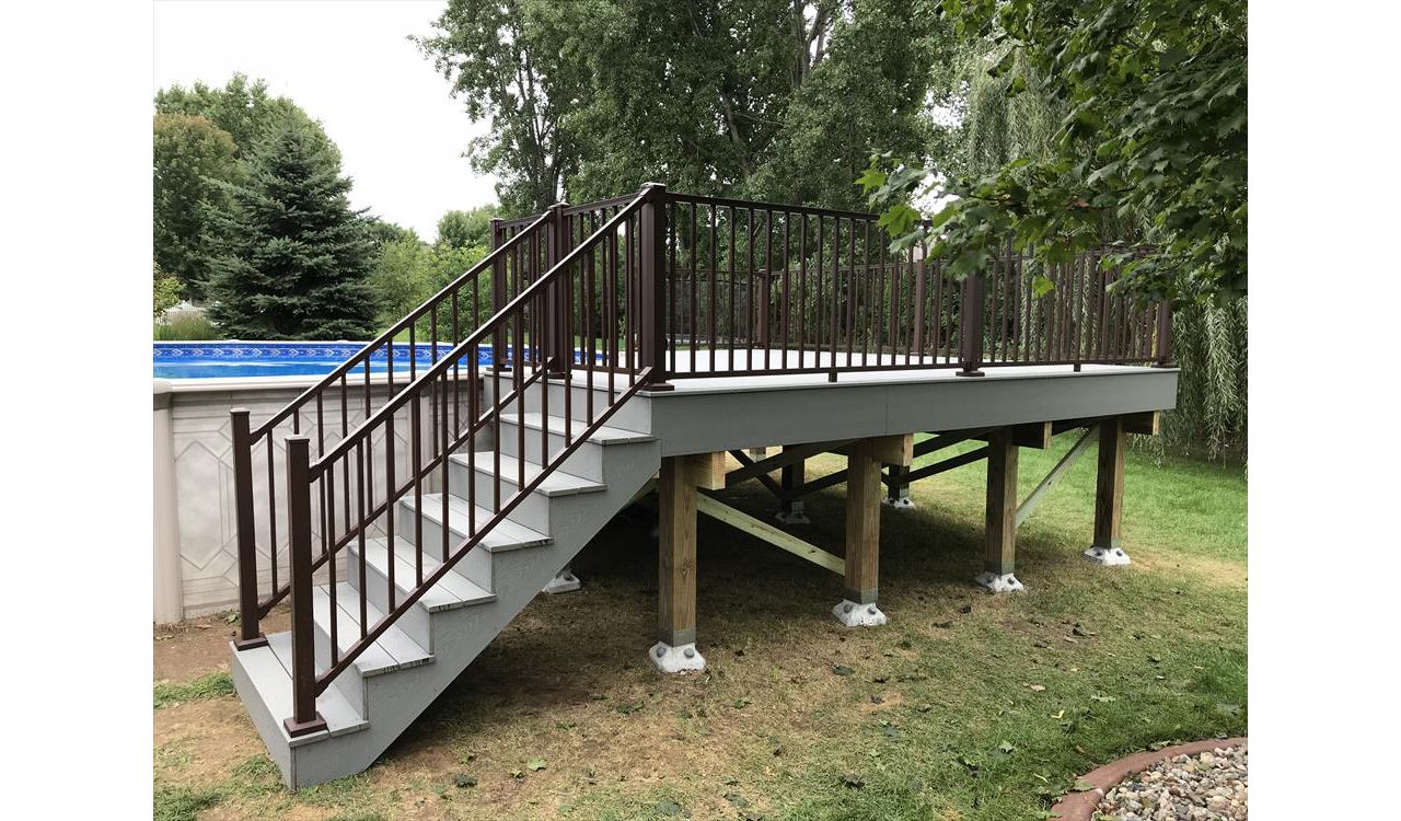Trex pool deck in Select Pebble Gray decking with Trex Signature bronze aluminum railings by GE Contracting LLC in DePere, WI