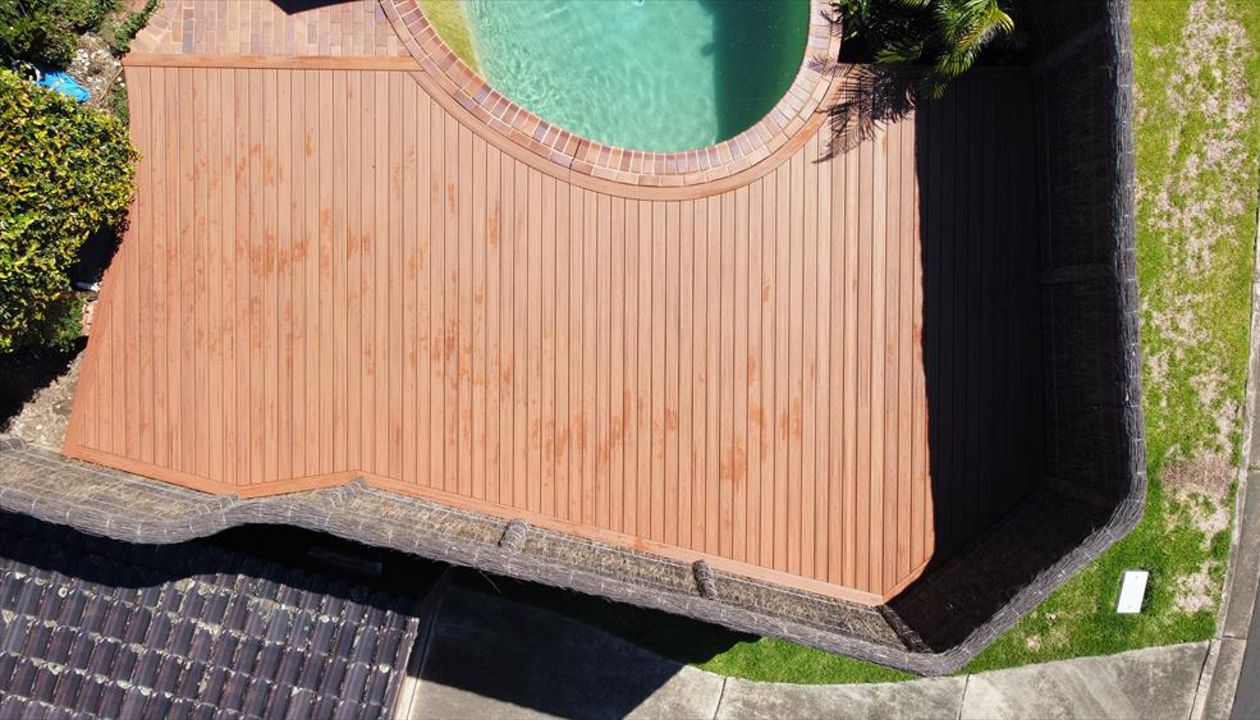 Trex tiki torch pool deck with custom curve to match pool edge and full boarder.